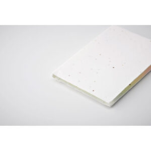Set Memo en papier comprenant 1 grand bloc-notes jaune et des marqueurs de couleur. La couverture contient des graines de marguerite. Après utilisation